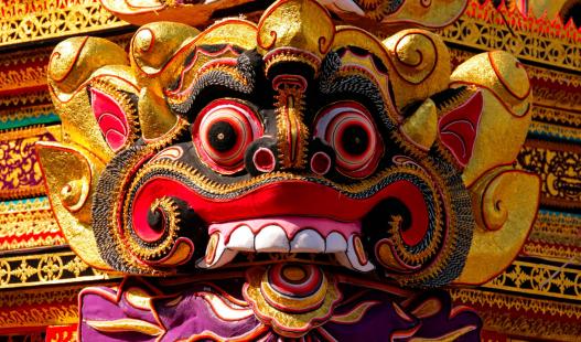 A vibrantly colored mask is featured in a Balinese cremation ceremony in Ubud, Bali.