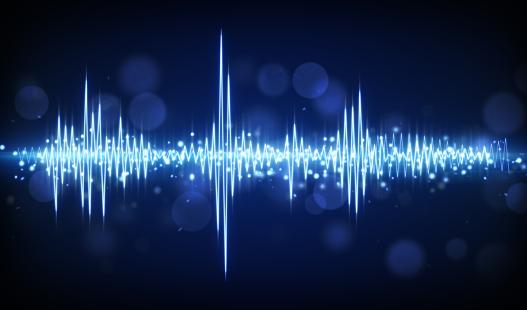 A blue audio waveform set against a dark background.