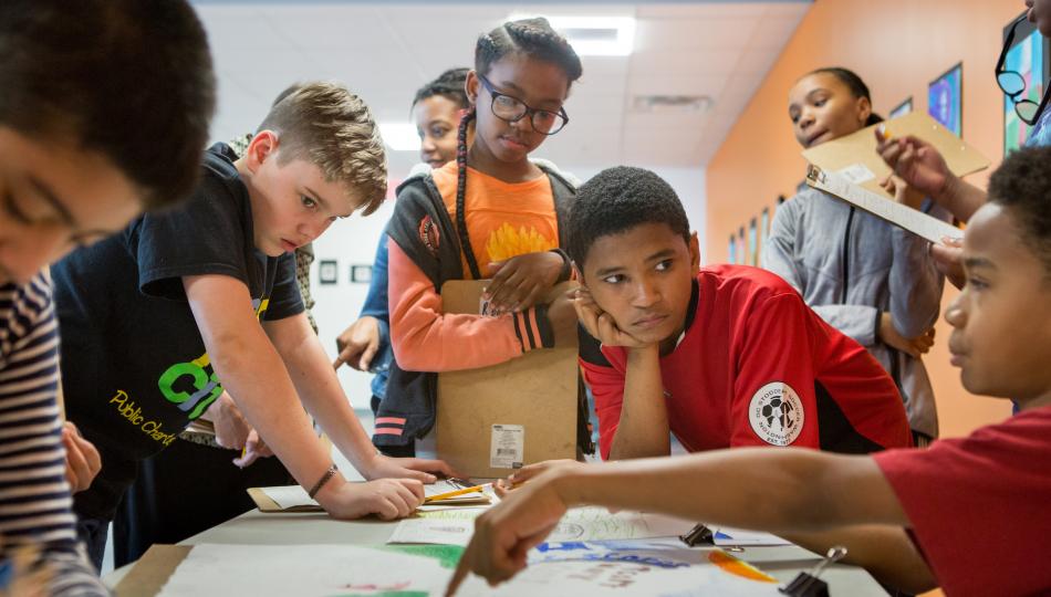 Group of students gathered around a table