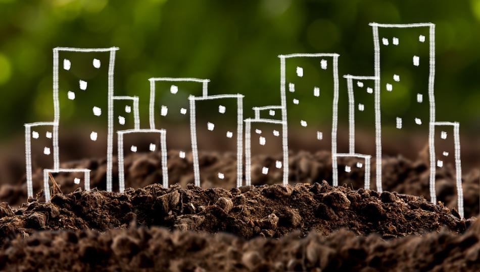 Conceptual image showing chalk drawings of cityscape growing out of the ground