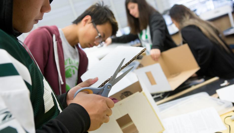 Group of students making structures out of cardboard