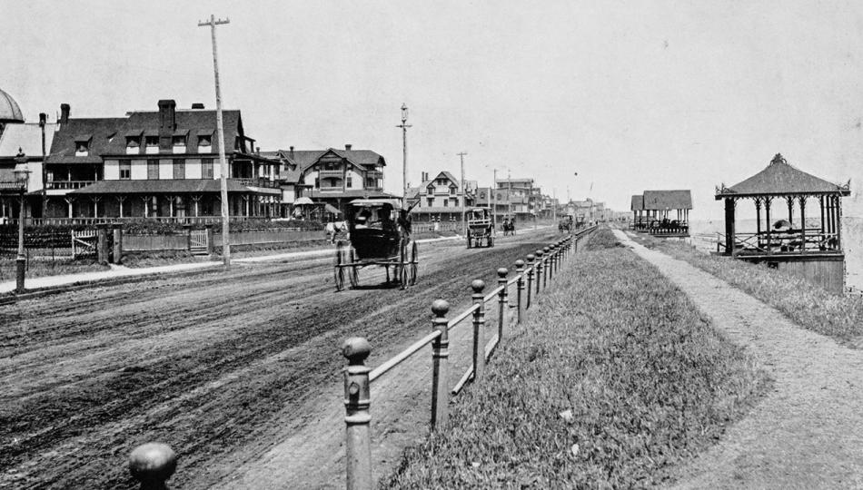 Antique black-and-white photograph of Ocean Avenue, Long Branch New Jersey, with two buggies going down a dirt road.