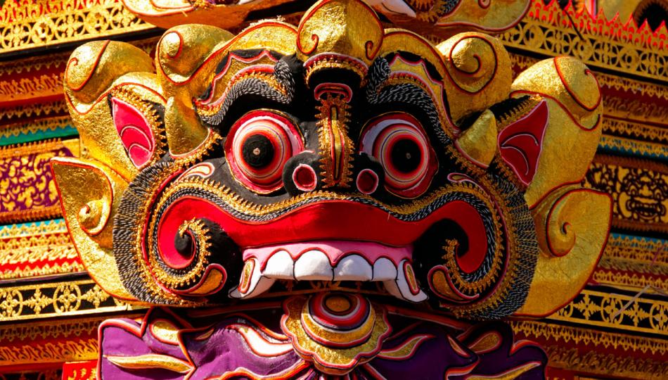 A vibrantly colored mask is featured in a Balinese cremation ceremony in Ubud, Bali.