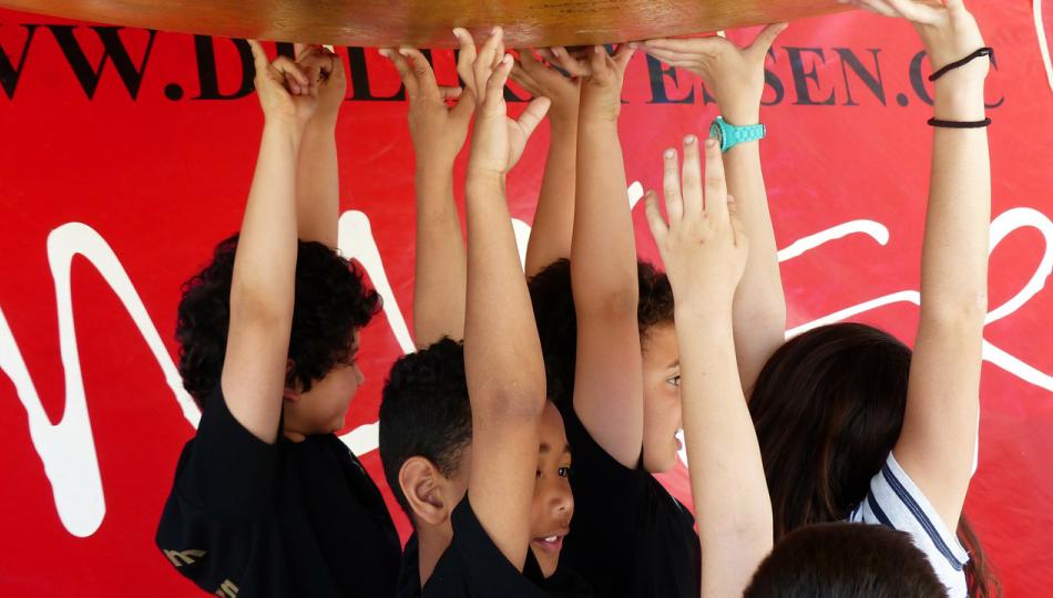 Image of children holding up a huge sphere