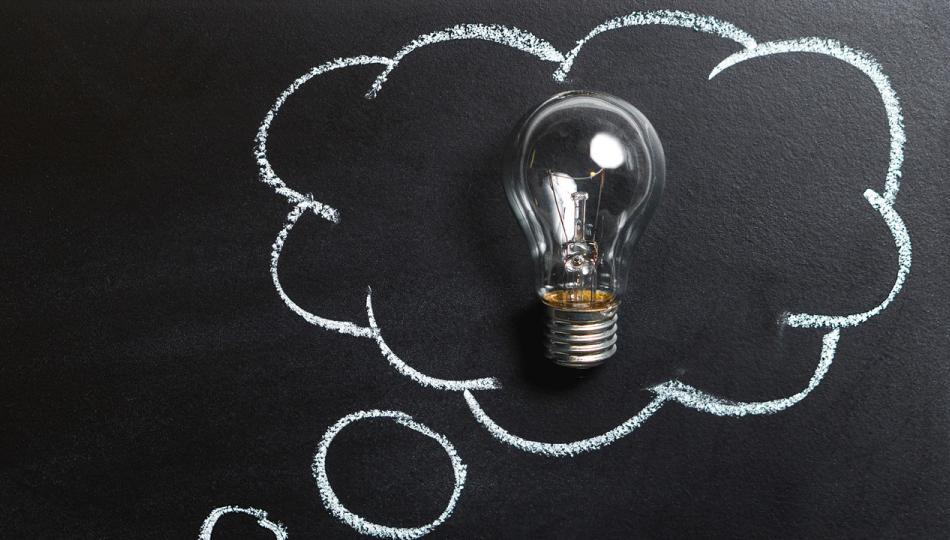 Image of a lightbulb framed by a chalkboard drawing of a thought balloon