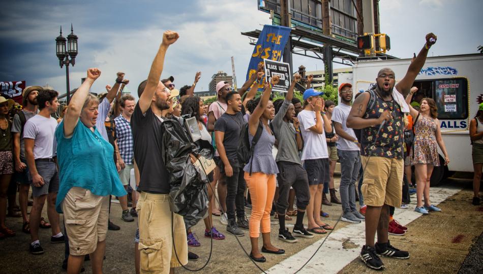Group of demonstrators with fists raised in the air