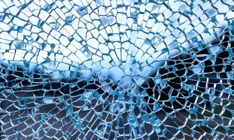 A blue, spider web-like pane of cracked glass.