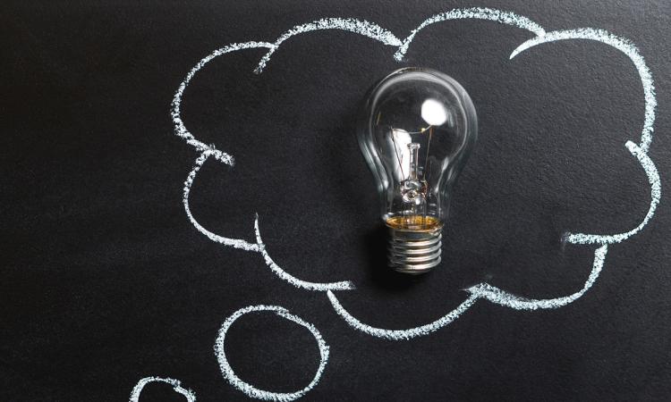 Image of a lightbulb framed by a chalkboard drawing of a thought balloon.