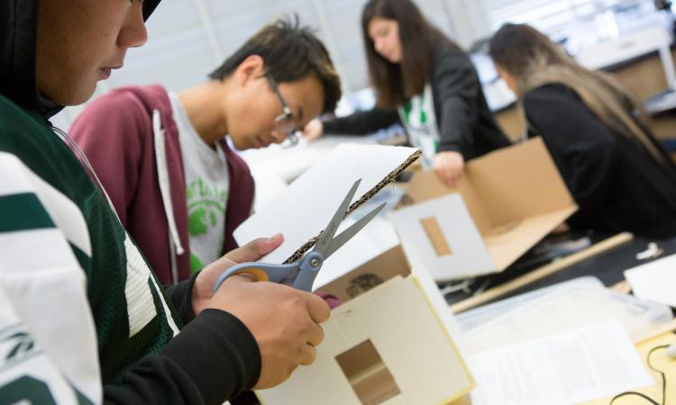 Group of students making structures out of cardboard