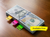 A stack of hundred dollar bills with labels reading "mortgage," "bills," and "food."