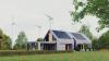 Modern eco house with solar panels and windmills to use alternative energy