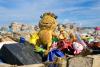 An abandoned dirty Garfield and other toys at a landfill